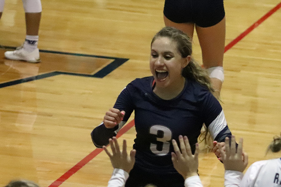 At the district match against East Central, senior libero Ashley Acuna celebrates after a 3-0 win.