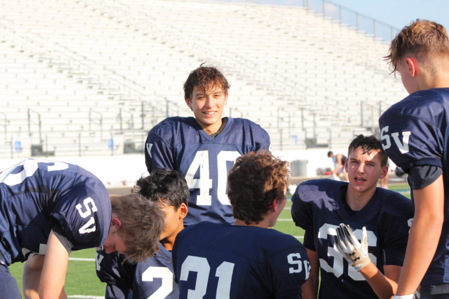 Sophomore Aiden Green (center) stands with his teammates during a timeout. Green and JV Blue are 8-0.