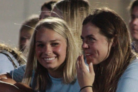 As juniors Caroline Haeze and Sarah Thorpe attend Fields of Faith, they share a laugh.