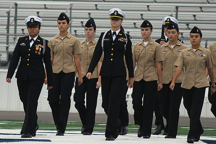 During the Veterans Day ceremony Monday at Ranger Stadium, members of the ROTC's armed and unarmed drill teams perform their routines.