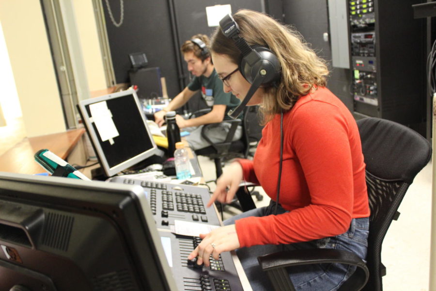 While the actors in the production theatre class rehearse onstage, senior Gracen Farmer controls the light board.