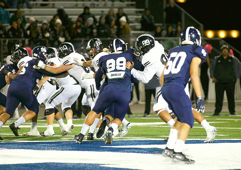 Trey Moore fights the Knights as he tries to break through Steele's offensive line. The Knights are also advancing to district playoffs.