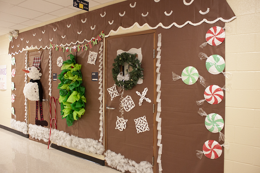 In C wing, Shauna Douglass's gingerbread house features a snowman made of Styrofoam cups and a tree made of tissue paper.