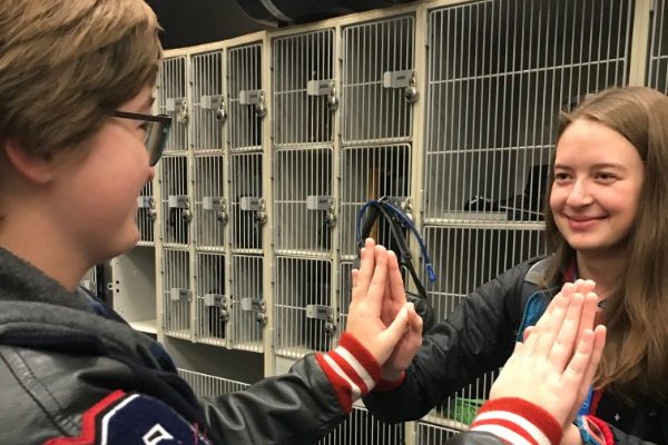 Before the start of school, seniors Carsyn Chambers (left) and Audrey Pauletti (right) share a moment of friendship in the band hall.