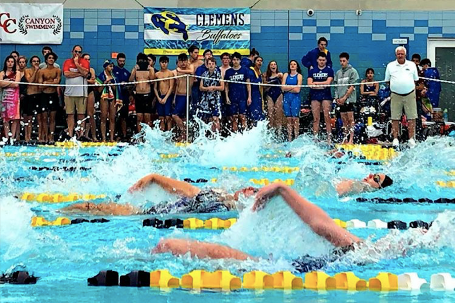 Girls compete in the 100 meter backstroke. Laney Skrobanek set a district record in the event.