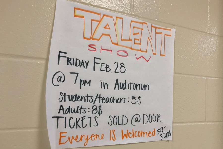Talent show flyer made by student council hangs in the A wing.