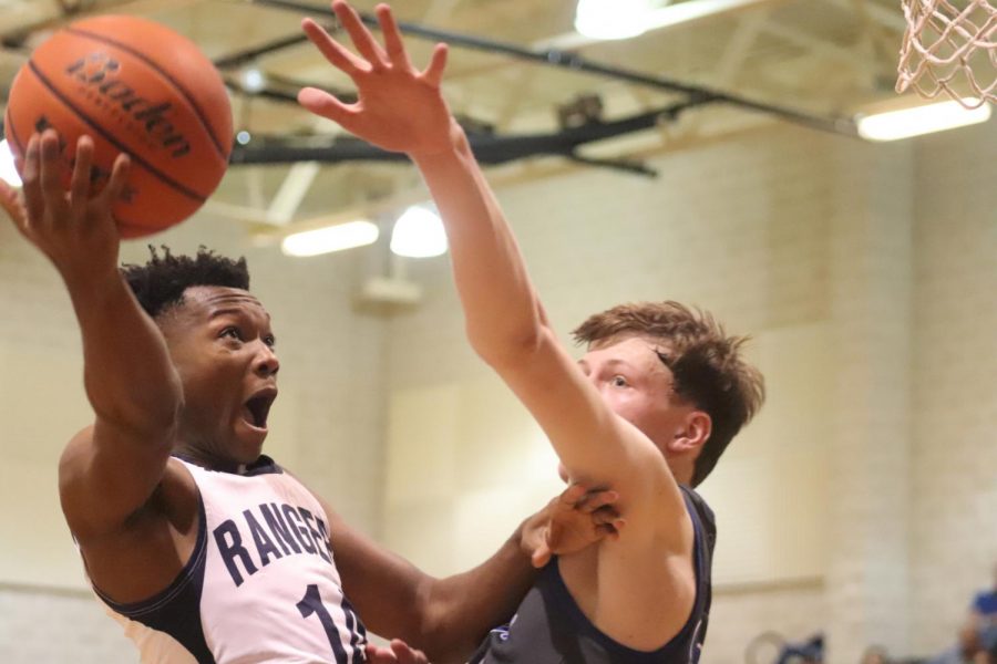 Devante Mount fights for a layup against New Braunfels. Mount was a key starter on basketball's first playoff team in a half-decade.