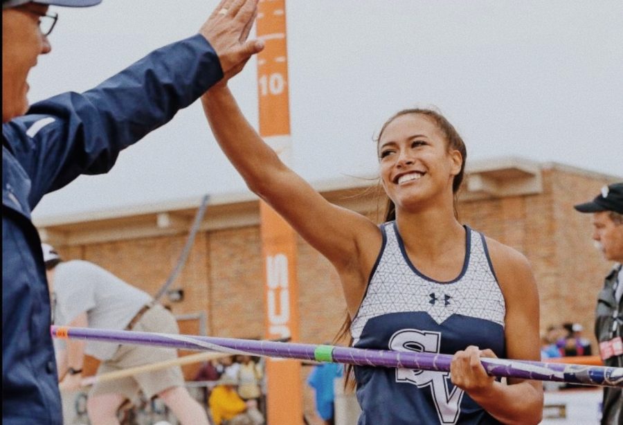 Avianna Trinidad high fives Coach Ulbricht after a good jump