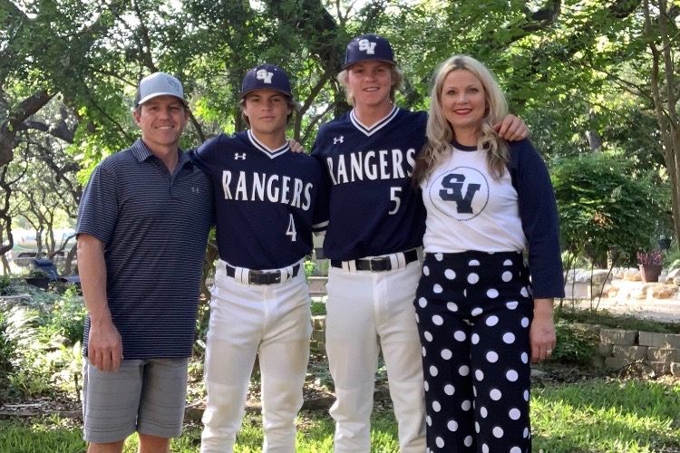 Brothers Kasen (center left) and Jarek Wells (center right) pose for end-of-year  photos. The two share a last name, but they're "more than brothers."