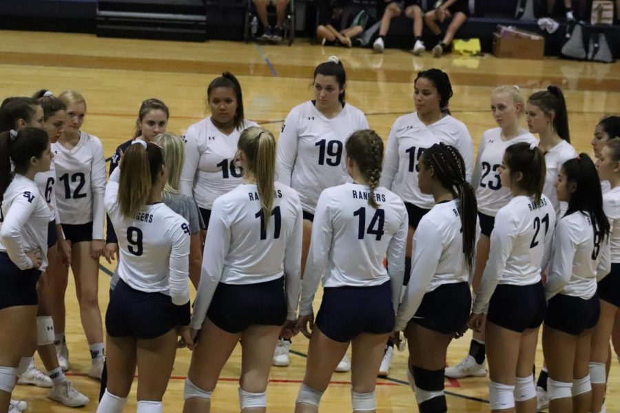 Team in a huddle at a home game