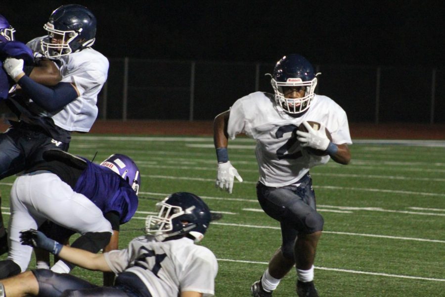 Running back Justin Avery totes the rock against San Marcos. Avery and the rest of the offense clicked Thursday, scoring eight touchdowns.