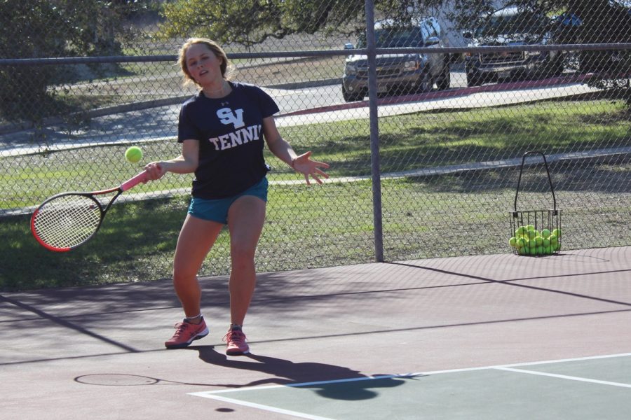 Senior Maddie Haas takes practice swings. She won two sets in the team's 17-4 victory.