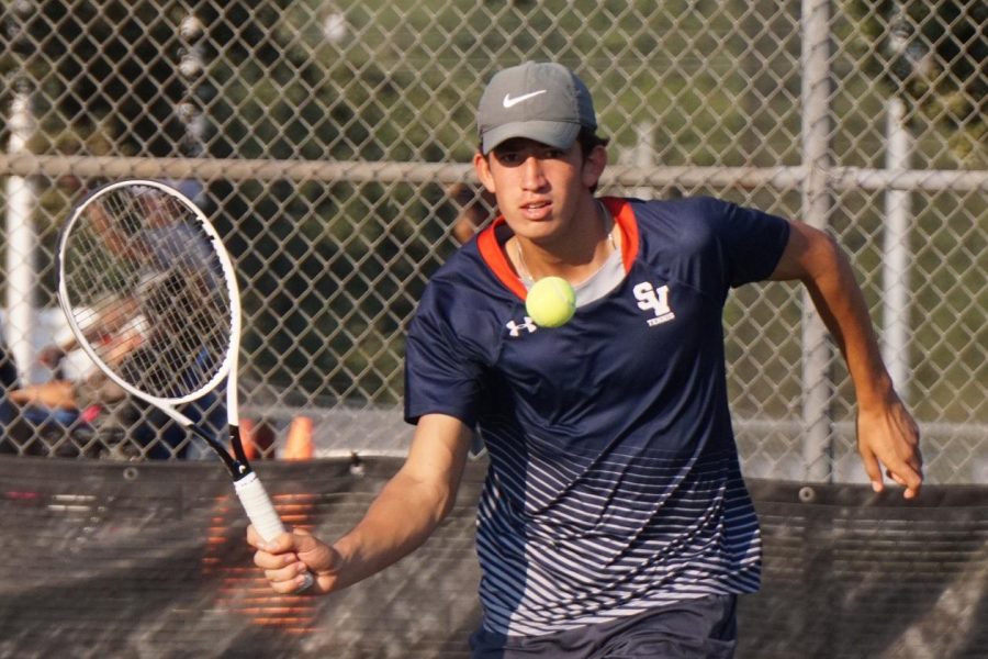Luke Cantu hits a volley