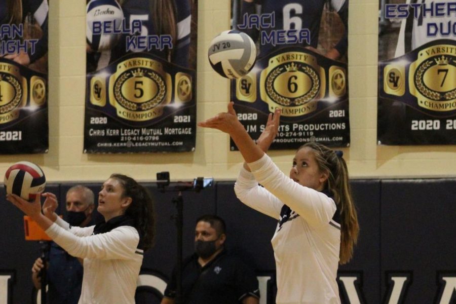 Junior Brianna Van Pelt and sophomore Reagan Elizondo warm up for a home game against New Braunfels.