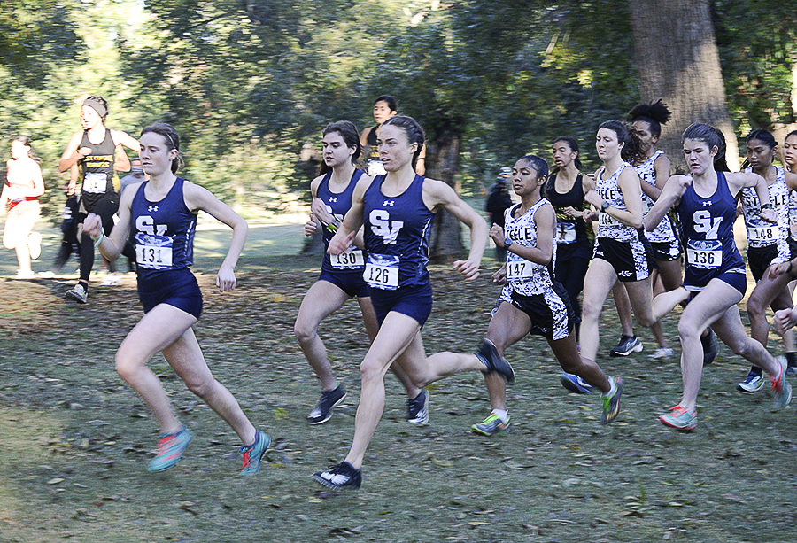 At the district meet on Friday, seniors Sara Scott and Amalie Mills lead the cross country team to another championship and trip to region.