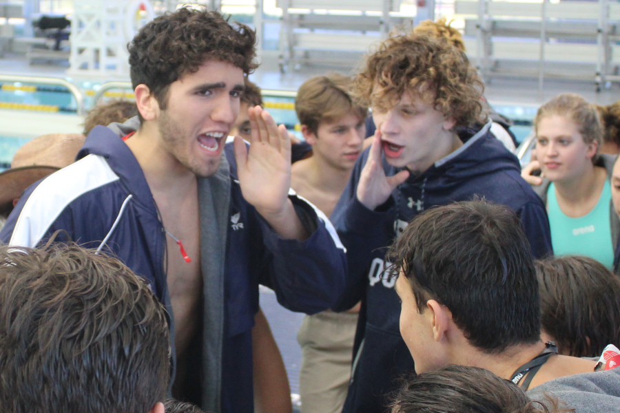Joe Hunt (left) and Carter Hill lead the team cheer at the 2019 District meet. Hill signed with Northern Michigan on Wednesday.