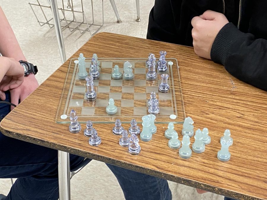 Two kids playing in chess club.