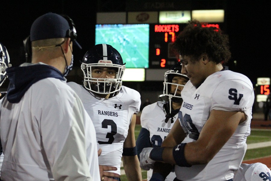 Defensive linemen Diego Hamilton (left) and Trey Moore (right) discuss tactics on the sideline. The defense will have their hands full Friday against a Westlake team averaging 54.9 points per game.