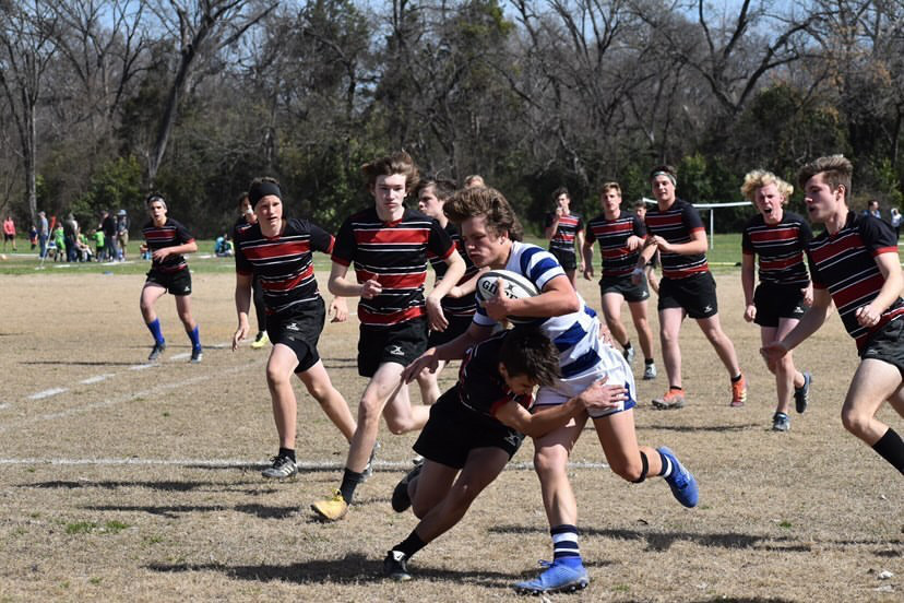 Tyler getting tackled with the ball