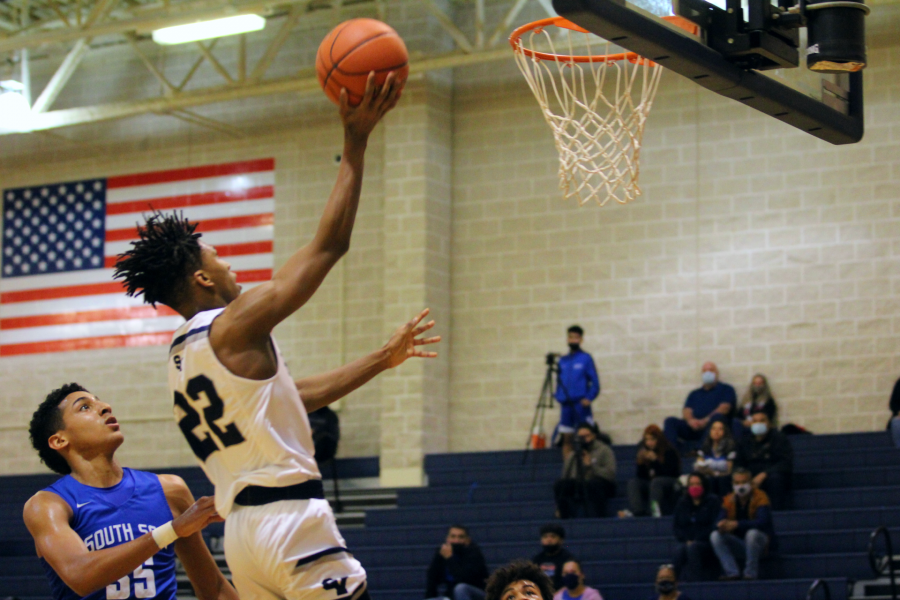 Tevijon Williams skies in for a transition layup over South San's Jonas Carlisle. Williams leads the Rangers with 2.1 steals per game.
