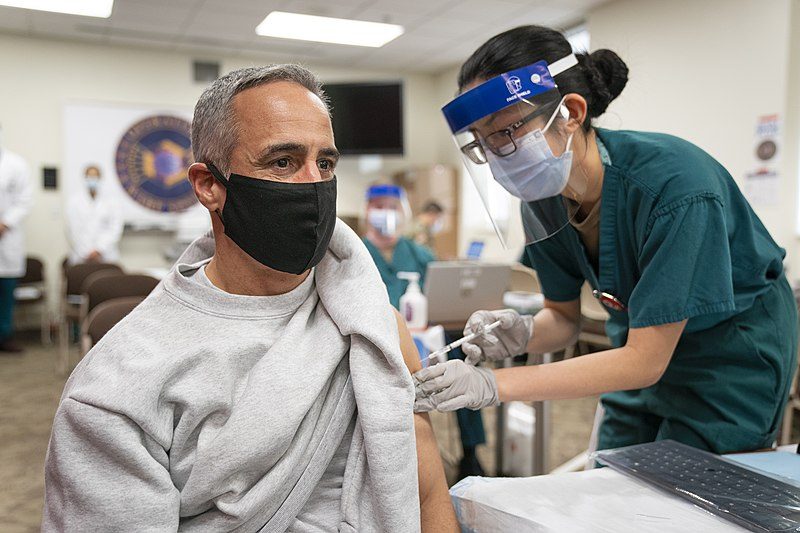 Senior Enlisted Advisor to the Chairman (SEAC) Ramon "CZ" Colon-Lopez receives a COVID-19 vaccine at Walter Reed National Military Medical Center, Bethesda, Md., Dec. 21, 2020. (DOD Photo by Navy Petty Officer 1st Class Carlos M. Vazquez II)

Image two: Bexar county has seen an average of 25 new COVID-19 deaths each day within the past week.

Image three: It is estimated that 140,00 people in Bexar county are included in Phase 1A.