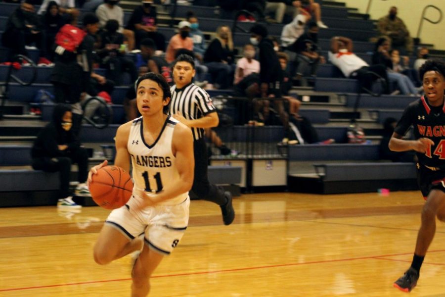 Eyeing the rim, Tristan Ortiz attacks on a fastbreak against Wagner on Jan. 22. Ortiz's 11.4 points per game have put boys basketball in position to push for a playoff berth.