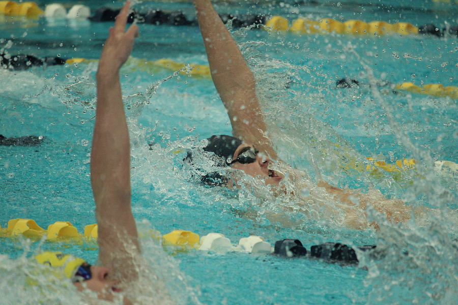 Colin Doyle swims backstroke in the 200 medley relay at the district championship.