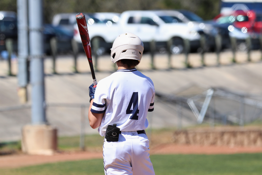 After adjusting his gloves, Kasen Wells steps into the batter's box. Wells, a junior, leads the team in OPS and stolen bases.