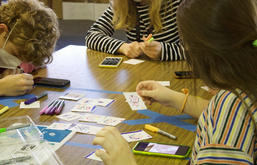 Sophomores Mason Mock and Ainsley Miliken decorate stickers to put outside of classrooms. On the stickers, students wrote phrases such as "This is a safe space" or "Your mental health matters."