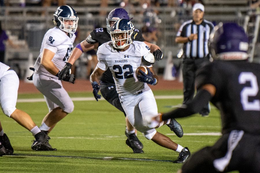 Malachi Lane rumbles up the middle against Warren. Lane, who rushed 10 times for 117 times, also captained the defense as a linebacker.