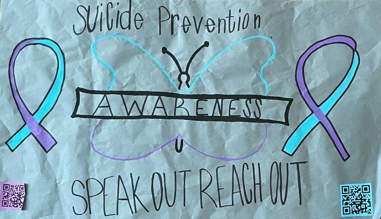 Suicide awareness posters are located around the school with QR codes for students looking for help.
