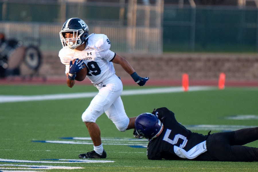 Brayden Bafidis outruns a defender on a punt return on Friday. Bafidis' special teams exploits led football to a 32-13 victory over Warren.