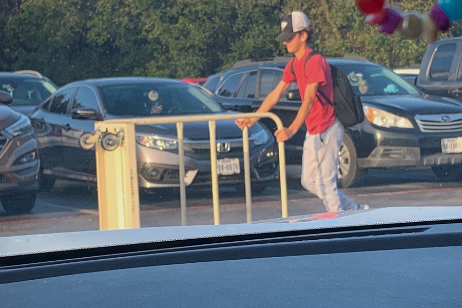 Waylon Shell rolls his "not a backpack" around the parking lot, the trolley will aid as his backpack for the day. 