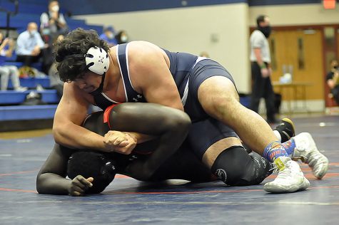 Taking his competitor to the mat, All-American wrestler Ryan Benca competes in the growing wrestling program in 2021.  He practices with the rest of his team in a renovated maintenance shed on campus.