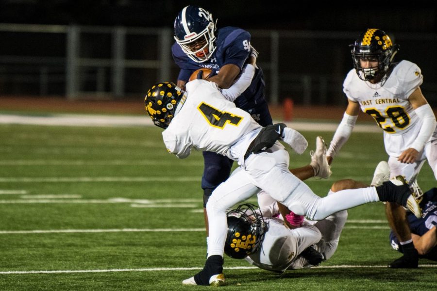 Malachi Lane stiff arms defender at the last home game of the regular season