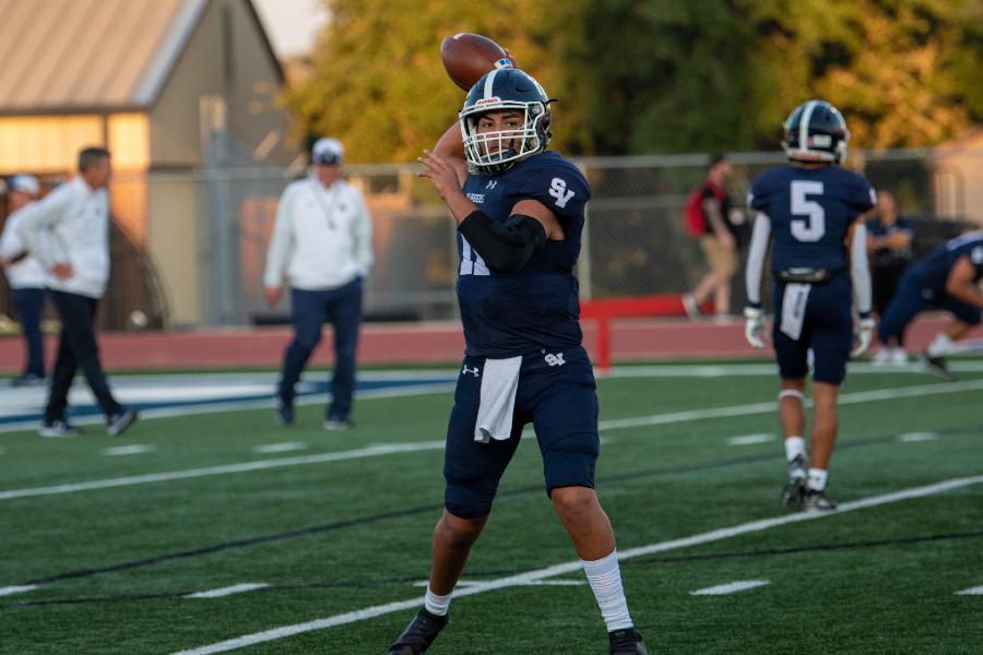 Derek Mata warms up his arm before playing Madison. Mata, a senior, passed for over 150 yards in football's season-ending loss to Bowie.