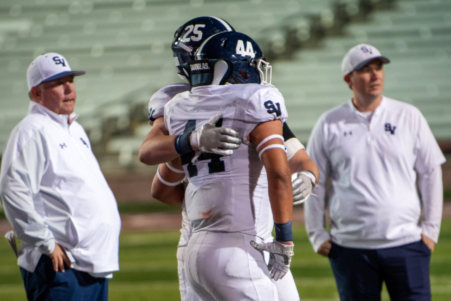 Jaxson Maynard (No. 25) comforts senior Kolton Scheppler after football's season-ending loss to Austin Bowie. The loss marked the end of Sports Director Jackson Posey's four-year run covering the team.