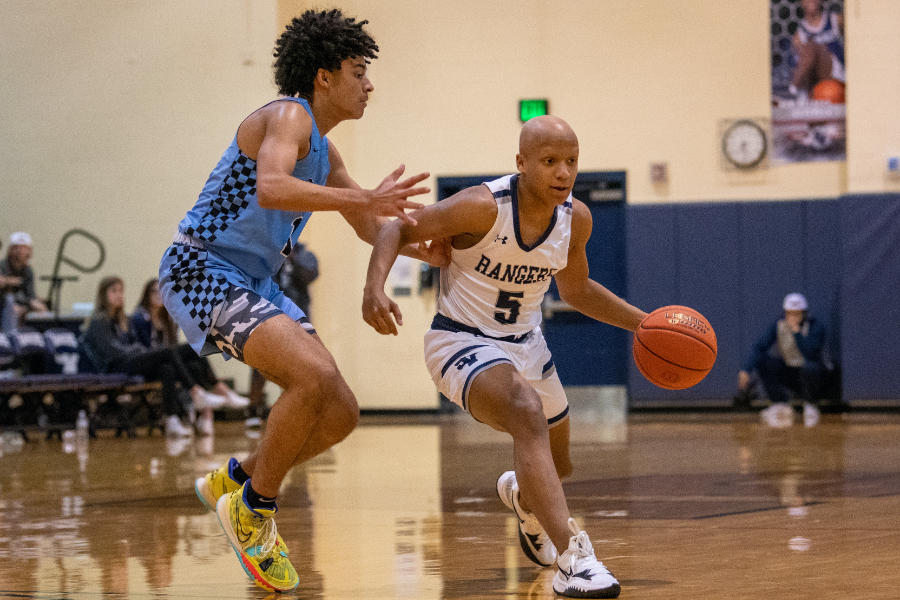 Evan Hingleton dribbles around a defender during a matchup against Harlan on Nov 30.