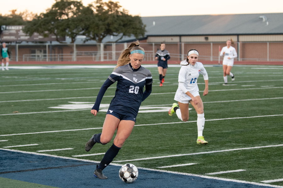 Senior Taylor Swenson dribbles up the field against MacArthur.