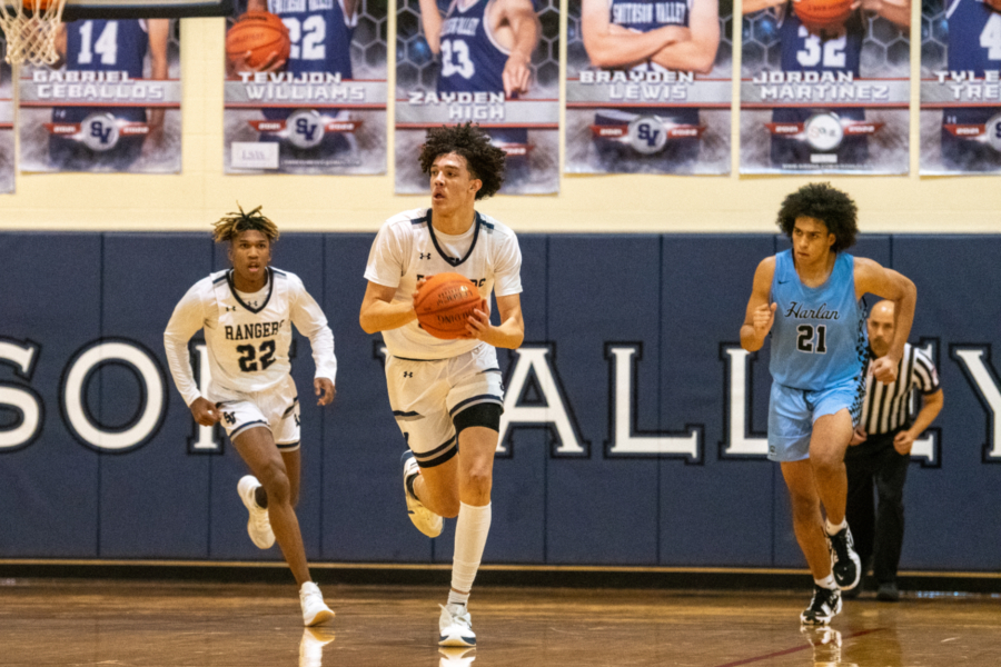 Zayden High dribbles down the court against Harlan on Nov 30.