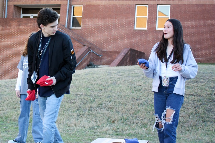 Junior member reacts surprisingly to her first round bean bag toss.