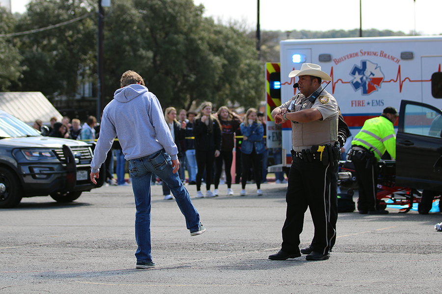 A police officer makes Waltman do a sobriety test after the crash.