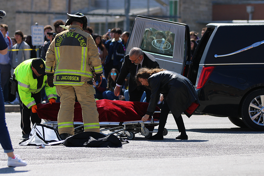 Malachi Lane is taken into a hearse after being pronounced "dead".