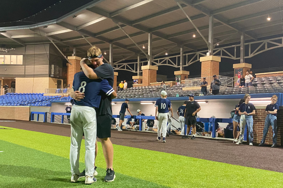 Team hype man Colton Thomasson (right) comforts starting pitcher Zach Gingrich after baseball's season-ending loss to Reagan. The Rangers finished the year 28-7, winning a district title and two playoff series along the way.