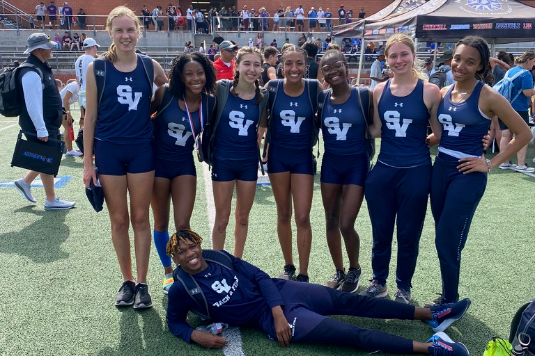 The girls regional team and Tevijon Willams pose following the Regional Championship meet.
