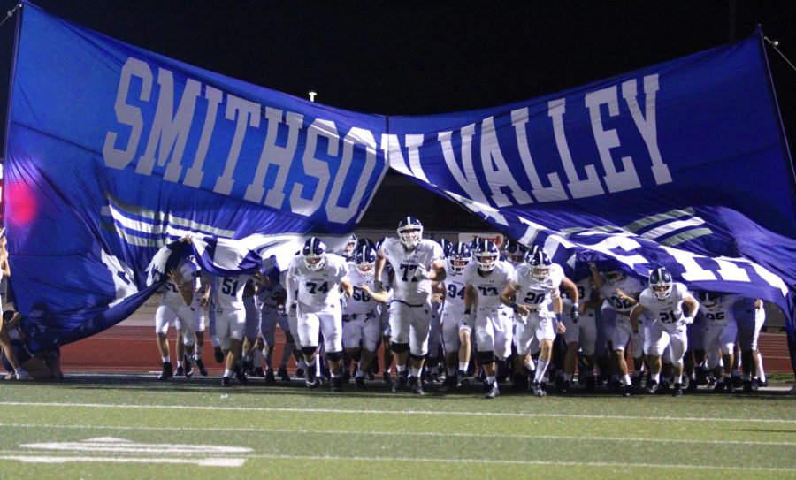 The Rangers run out on the field against Wagner. 