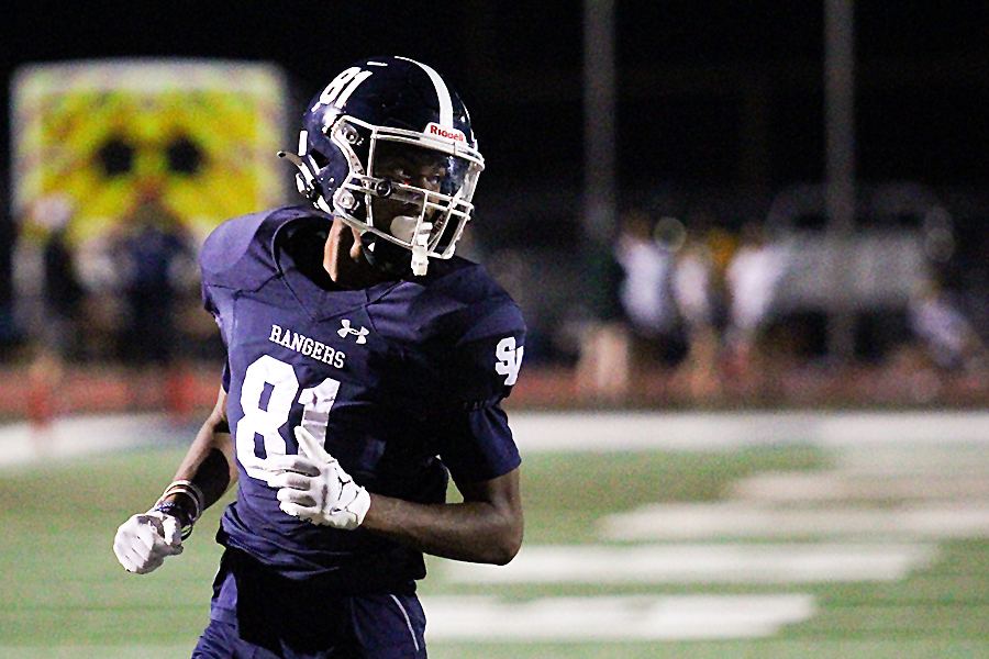 At the end of the second quarter, senior wide receiver T.J. Hunt gets into position for the snap. Hunt scored on two touchdowns in the last minutes of the first half.