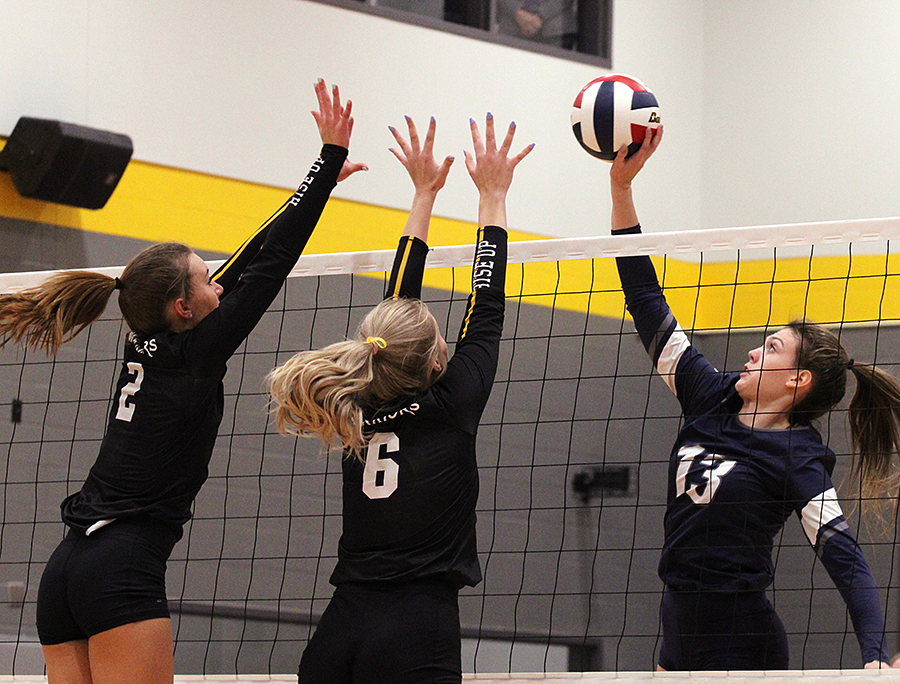 Senior middle blocker Lillie Johnson goes up against  two Pieper players Sept. 9 at Pieper. Johnson and senior libero Brittan Fedyk were named to the American Volleyball Coaches Association  All-American Watchlist, which recognizes the best senior volleyball players in the country.