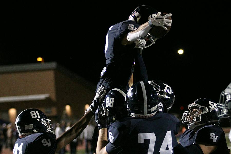 Senior Kyler Clarke gets lifted up after scoring a touchdown.