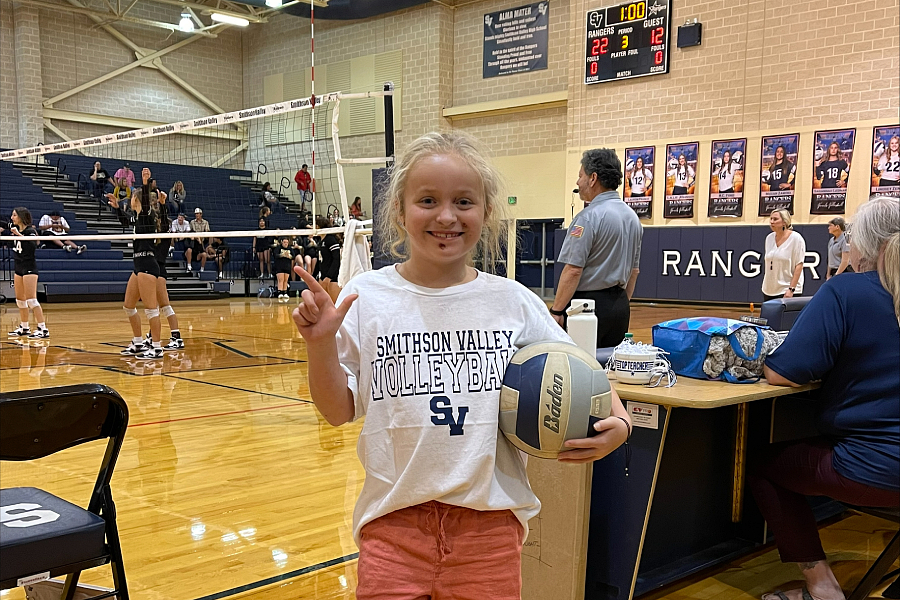 Henley Gieringer, 7, supports the high school's volleyball team.